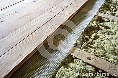 Installation of new floor of wooden natural planks and mineral wool insulation for isolation and keeping warmth. Modern technologi Stock Photo