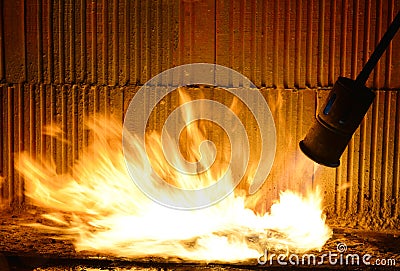 Installation of roll waterproofing propane blowtorch. Stock Photo