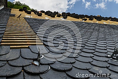 Installation of slate roofing Tiles on a roof Stock Photo