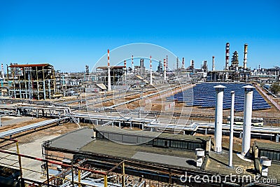 Installation of solar panels at anPart of the technological column at the refinery for the manufacture of light petroleum products Stock Photo