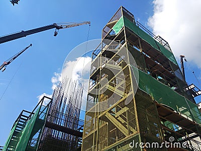 Installation of temporary scaffolding for the construction of tall concrete structures. Editorial Stock Photo