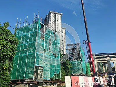 Installation of temporary scaffolding for the construction of tall concrete structures. Editorial Stock Photo