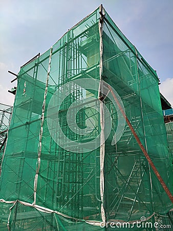 Installation of temporary scaffolding for the construction of tall concrete structures. Editorial Stock Photo