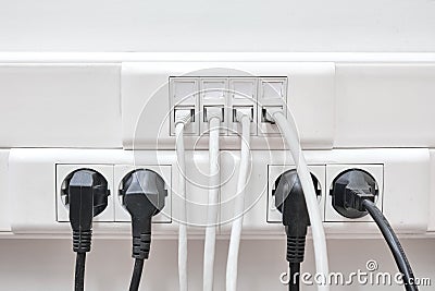 Installation of wires in electrical and local network sockets. Connecting and disconnecting computers in the office lan Stock Photo