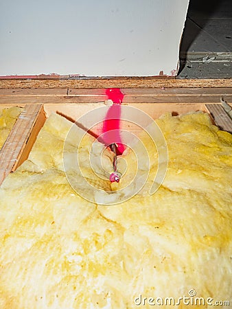 Installation of wooden beams and isolation wool. Warming of floor Stock Photo