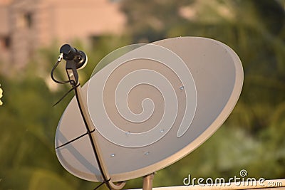 Installed dish or DTH or Direct to home tv on the roof against blur background, which is used for receiving TV programs Stock Photo