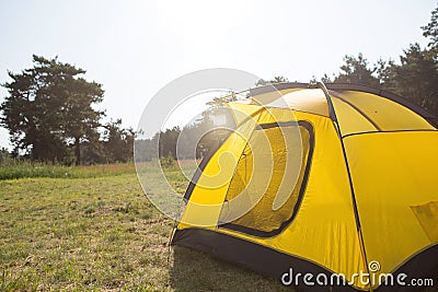 Installed tourist tent in nature in the forest. Domestic tourism, active summer holidays, family adventures. Ecotourism, social Stock Photo