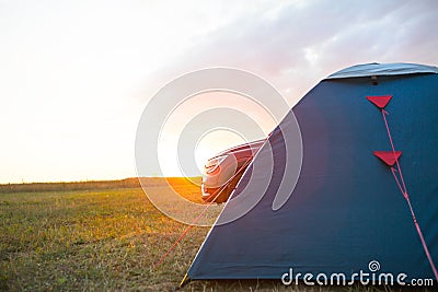 Installed tourist tent near the car. Domestic tourism, active summer trip, family adventures, auto camping. Ecotourism. Travel by Stock Photo