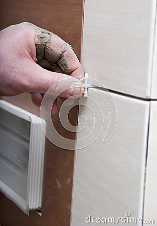 Installing bathroom tile Stock Photo