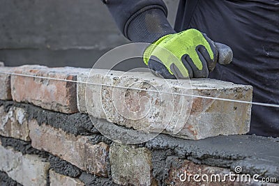 Installing brick, build a brick wall 2 Stock Photo
