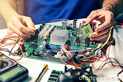 Installing computer hardware - technician install CPU on motherboard Stock Photo
