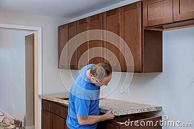 Installing contractors a laminate counter top a kitchen remodel Stock Photo