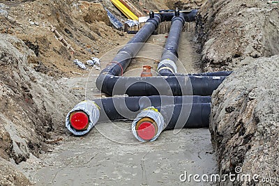 Installing district heating pipes in a trench Editorial Stock Photo