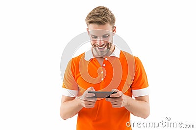 Installing game. Exciting gaming. Mobile repair. Happy handsome man hold cell phone. 5G fast connection. Mobile Stock Photo