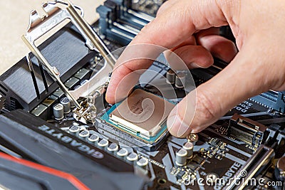 Installing the Intel i7-9700K central processor on the Gigabyte motherboard. The CPU is installed in the motherboard Editorial Stock Photo
