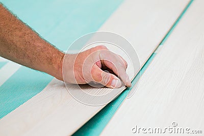 Installing laminate floor with wooden texture Stock Photo