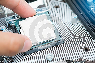 The engineer Installing CPU in socket computer motherboard Stock Photo