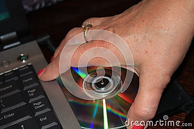 Installing program from DVD to laptop computer - Image Stock Photo