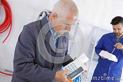 Installing programmable room thermostat Stock Photo