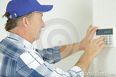 installing programmable room thermostat Stock Photo