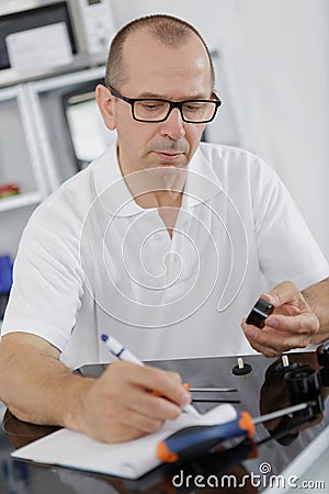 Installing programmable room thermostat Stock Photo