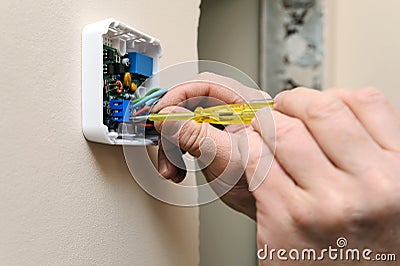 Installing a programmable room thermostat. Stock Photo