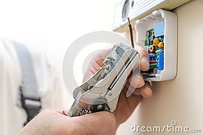Installing a programmable room thermostat. Stock Photo