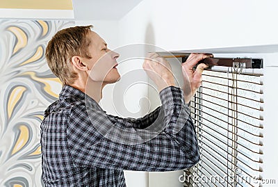 Installing wooden blinds. Stock Photo