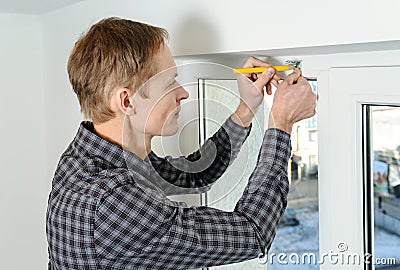 Installing wooden blinds. Stock Photo