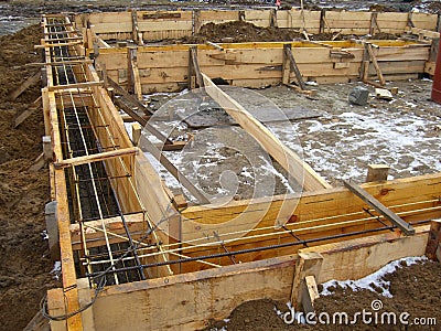 Installing wooden forms for pouring the Foundation concrete trench reinforced with reinforcement made of fiberglass Stock Photo