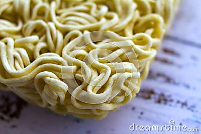 Instant asian yellow noodles on white wooden table. Stock Photo