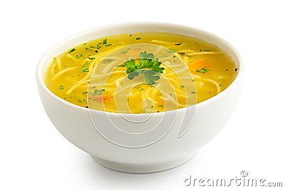 Instant chicken noodle soup in a white ceramic bowl isolated on white. Parsley garnish Stock Photo