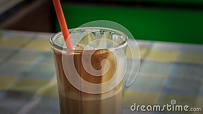 Instant coffe in a glass with a red straw Stock Photo