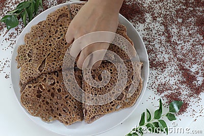 Instant Finger Millet Dosa, made with finger millet flour, curd and spices. Rich in proteins, calcium and fiber Stock Photo