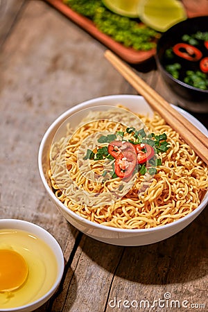 Instant noodle in bowl cooked spicy taste topping with eggs Stock Photo