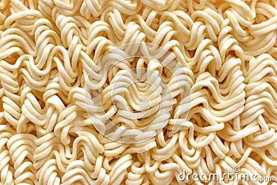 Instant noodles texture background. Uncooked egg noodle. Stock Photo