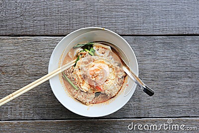 Instant noodles tom yum and spoon with wooden fork on wooden background, Sodium diet high risk kidney failure, Healthy eating Stock Photo