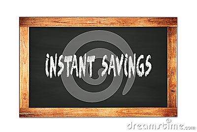 INSTANT SAVINGS text written on wooden frame school blackboard Stock Photo