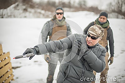 Instructor demonstrate action combat tactical gun shooting to his students Stock Photo