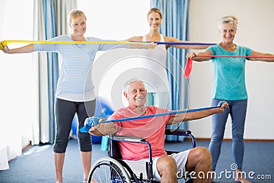 Instructor and seniors exercising with stretching bands Stock Photo