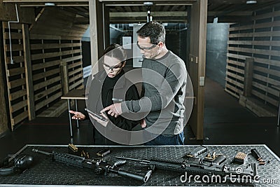 instructor showing pistol to customer Stock Photo