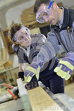 Instructor showing trainee carpentry work Stock Photo