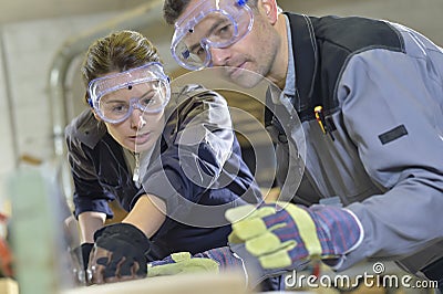 Instructor showing trainee carpentry work Stock Photo