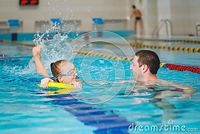 Instructor teaches the girl swimming in a pool Stock Photo