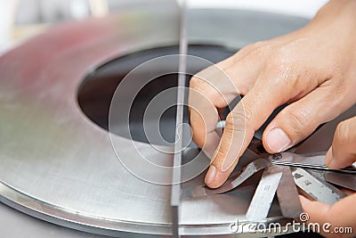 Instrument technician measuring flatness of orifice plate by using filler gauge for inspect the condition of measurement element Stock Photo