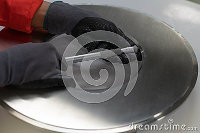 Instrument technician measuring orifice plate of gas flow measurement element by using micro meter Stock Photo