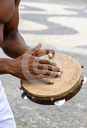 Instrumentalist playing tambourine in the streets of Pelourinho Stock Photo