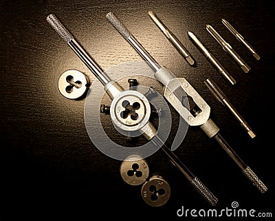 Instruments. Tools for threading. A set of taps and dies for threading. Stock Photo