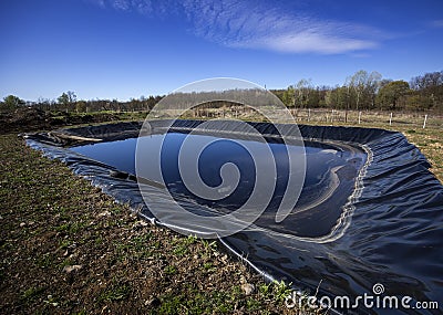 Insulated leachate pond with dirty water, part of landfill Stock Photo