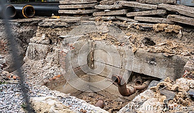 Insulated pipes and concrete slabs in trench outdoors Stock Photo